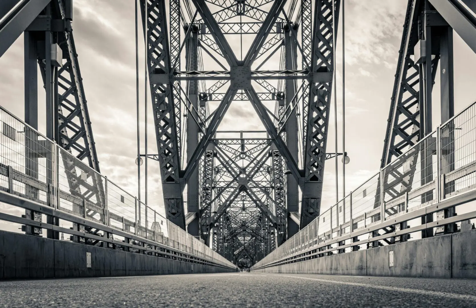 A black and white photo of an old bridge.