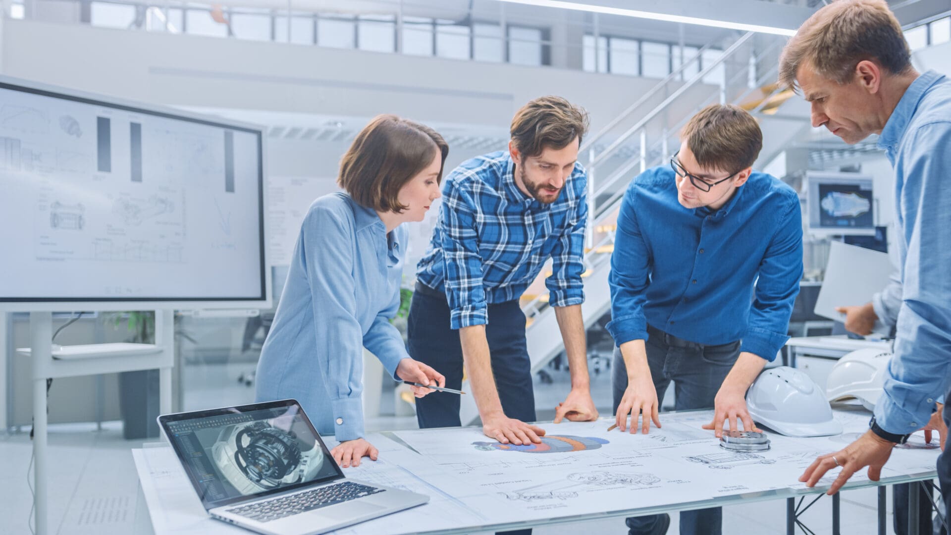 A group of people standing around a table.