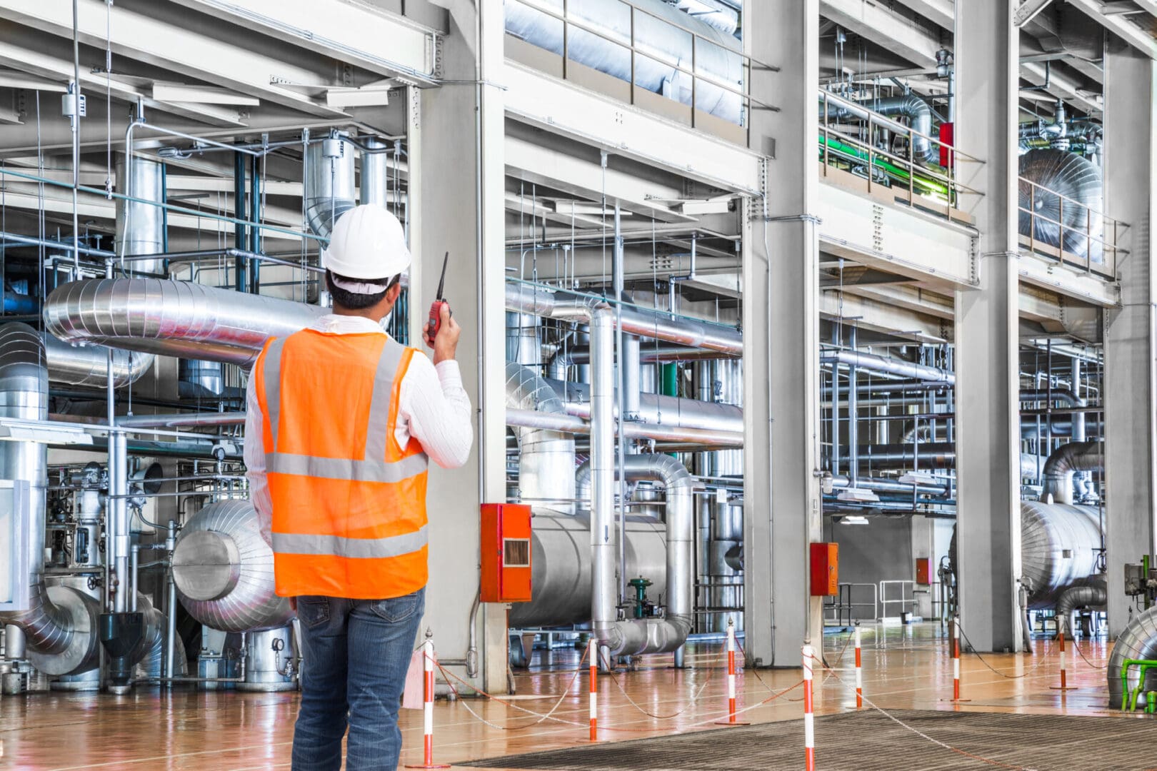 A man in an orange vest and hard hat.